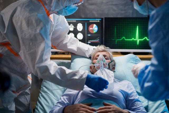 Infected Patient In Quarantine Lying In Bed In Hospital, Coronav